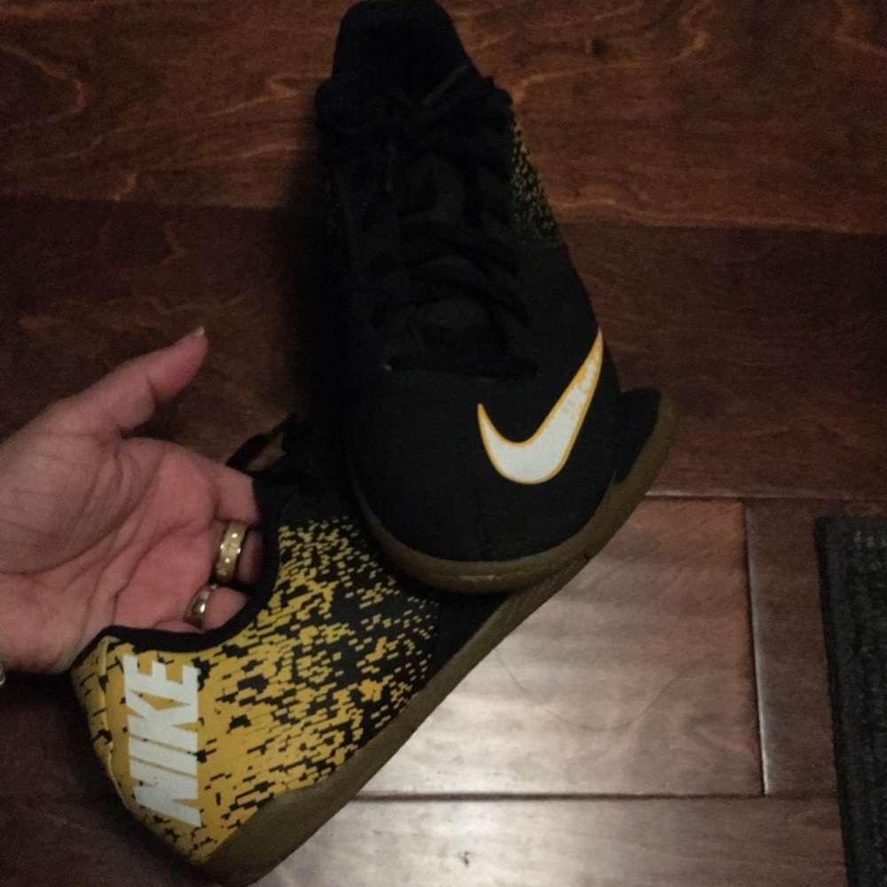 Black and yellow indoor soccer shoes.
